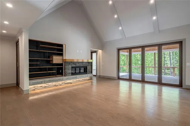 a view of an empty room with a fireplace and a window