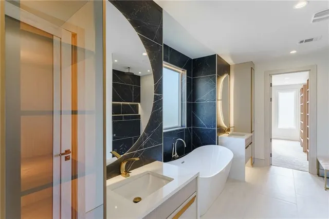 a large white kitchen with stainless steel appliances
