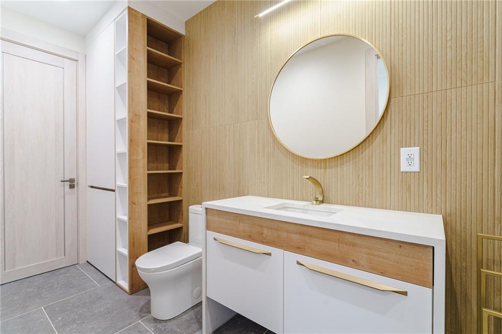71 Ramey Road Sugar Hill, GA 30518 - Photo 42 of 58 a bathroom with a sink a toilet and a mirror