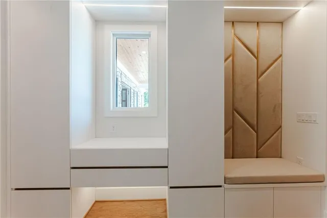 a large kitchen with stainless steel appliances and white cabinets