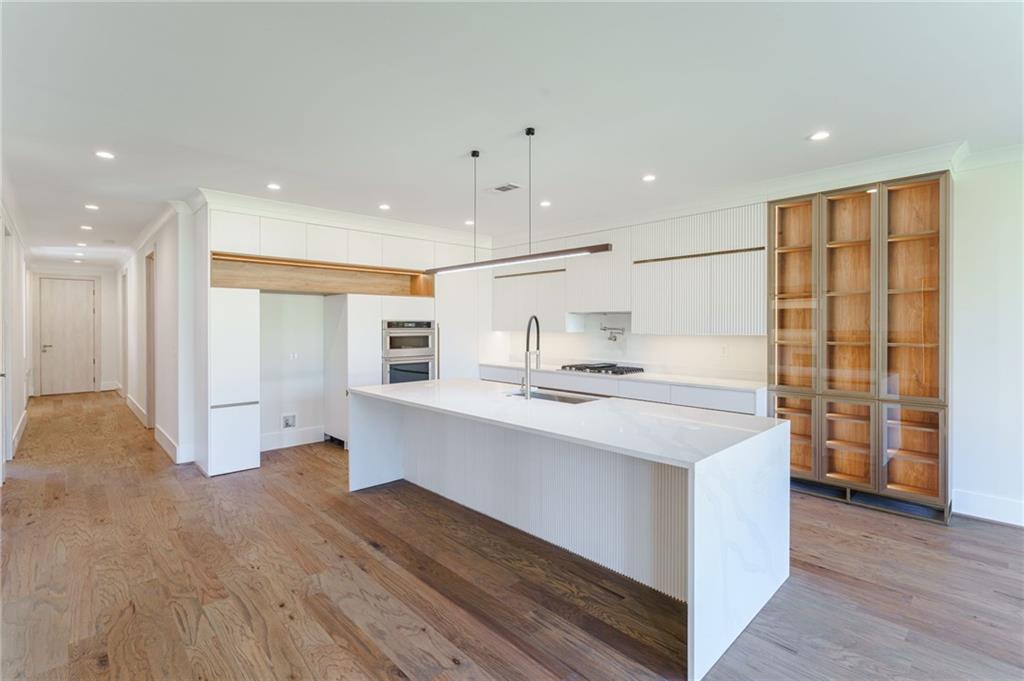 71 Ramey Road Sugar Hill, GA 30518 - Photo 45 of 58 a kitchen with stainless steel appliances sink refrigerator and wooden floor