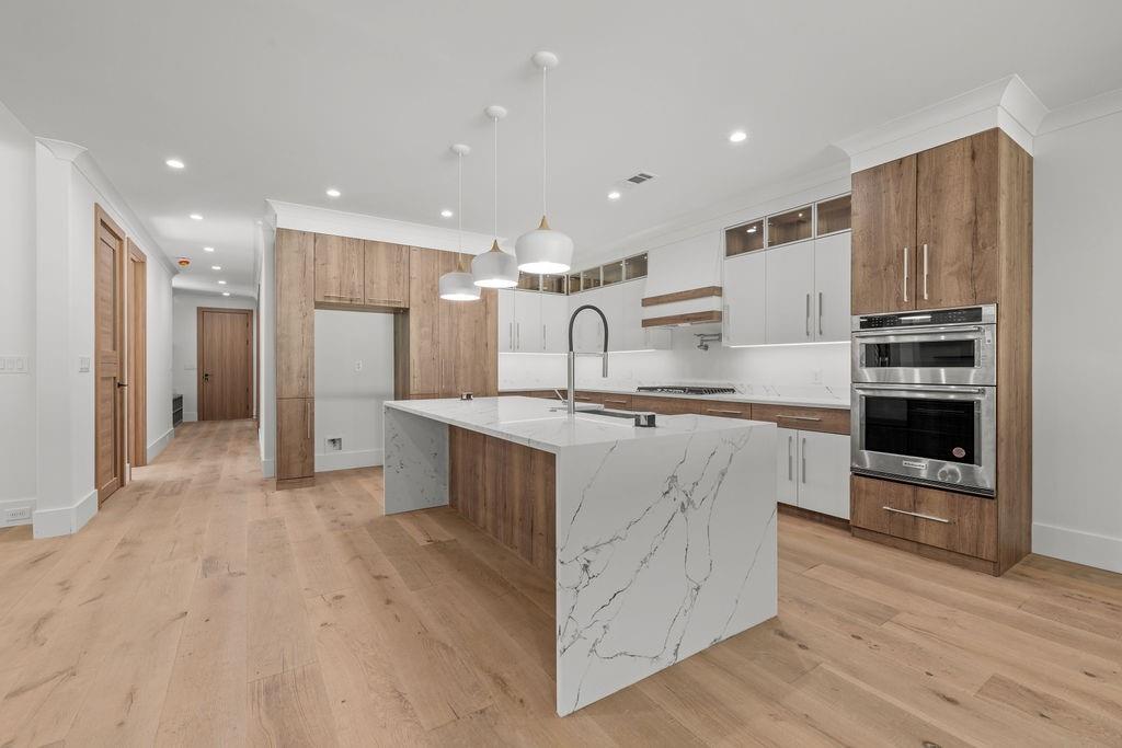71 Ramey Road Sugar Hill, GA 30518 - Photo 50 of 58 a kitchen with stainless steel appliances kitchen island wooden cabinets and granite counter tops