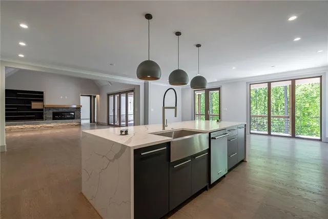 a kitchen with stainless steel appliances granite countertop a sink and stove