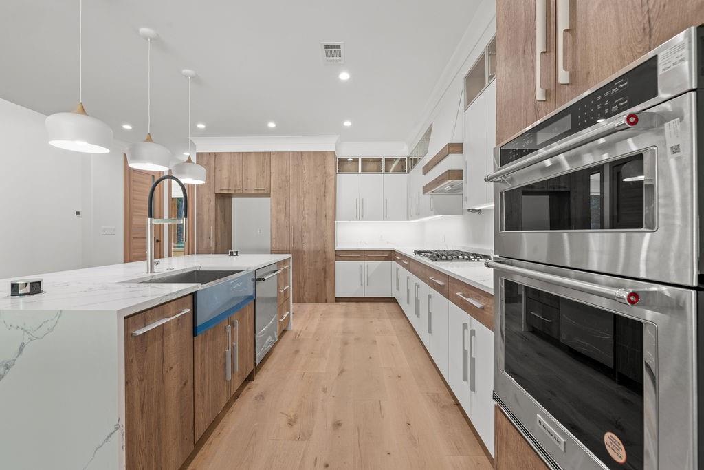 71 Ramey Road Sugar Hill, GA 30518 - Photo 51 of 58 a large kitchen with stainless steel appliances and white cabinets