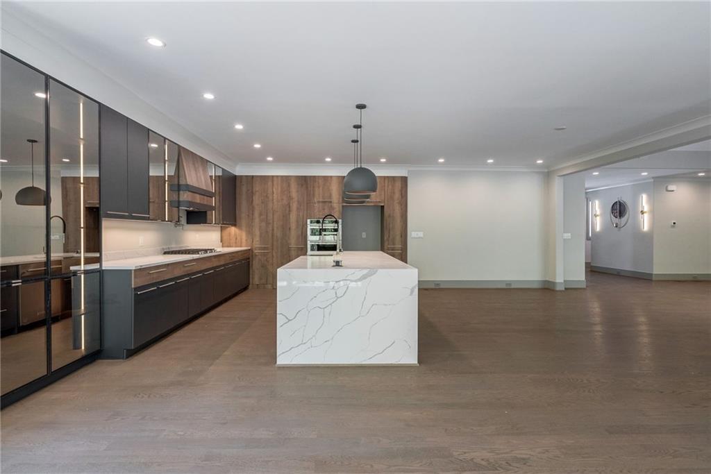 71 Ramey Road Sugar Hill, GA 30518 - Photo 6 of 58 a large kitchen with stainless steel appliances kitchen island a large counter top a stove and a sink