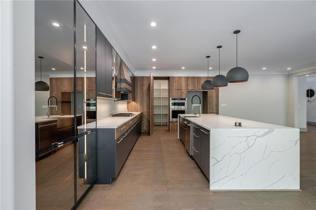 71 Ramey Road Sugar Hill, GA 30518 - Photo 9 of 58 a large kitchen with a large counter top and stainless steel appliances