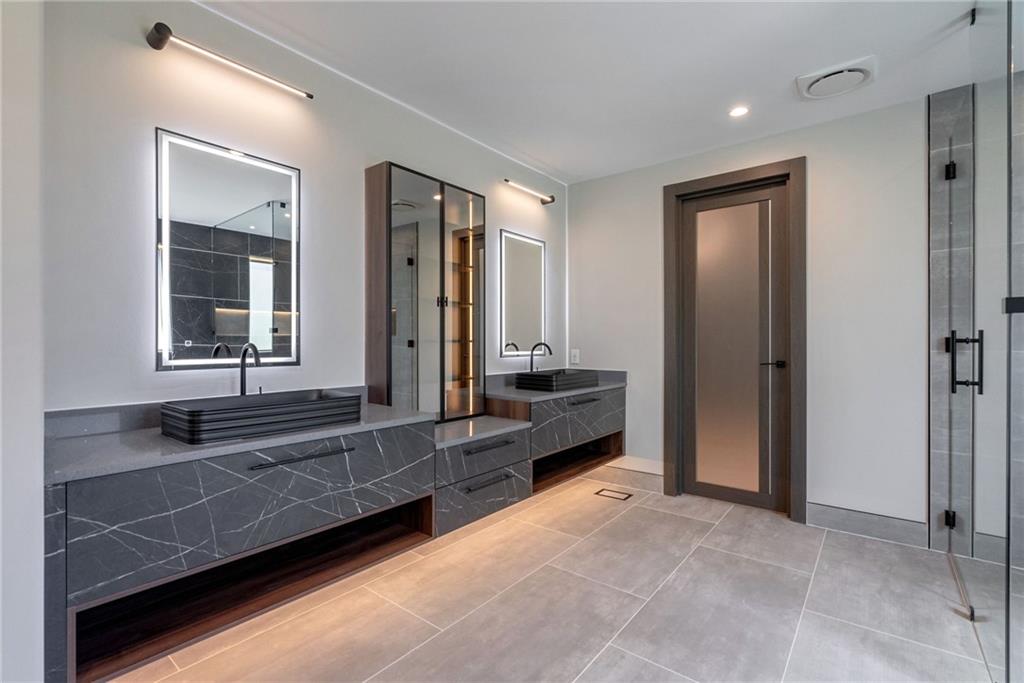 71 Ramey Road Sugar Hill, GA 30518 - Photo 10 of 58 a spacious bathroom with a tub and a large mirror