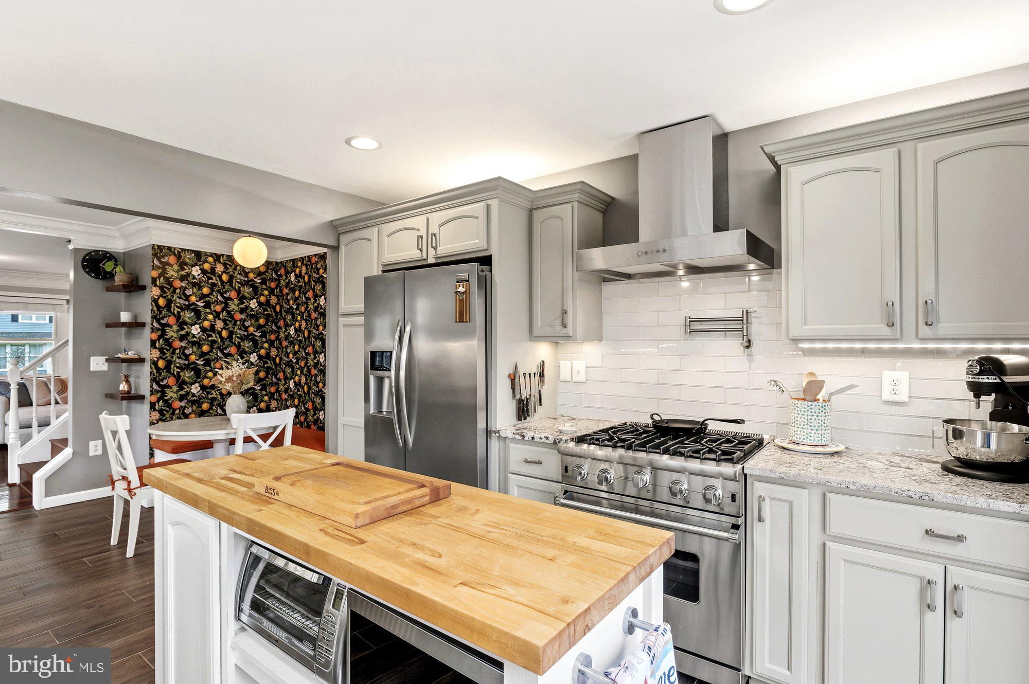 6809 Duke Drive Alexandria, VA 22307 - Photo 11 of 30 a kitchen with stainless steel appliances granite countertop a sink stove and refrigerator