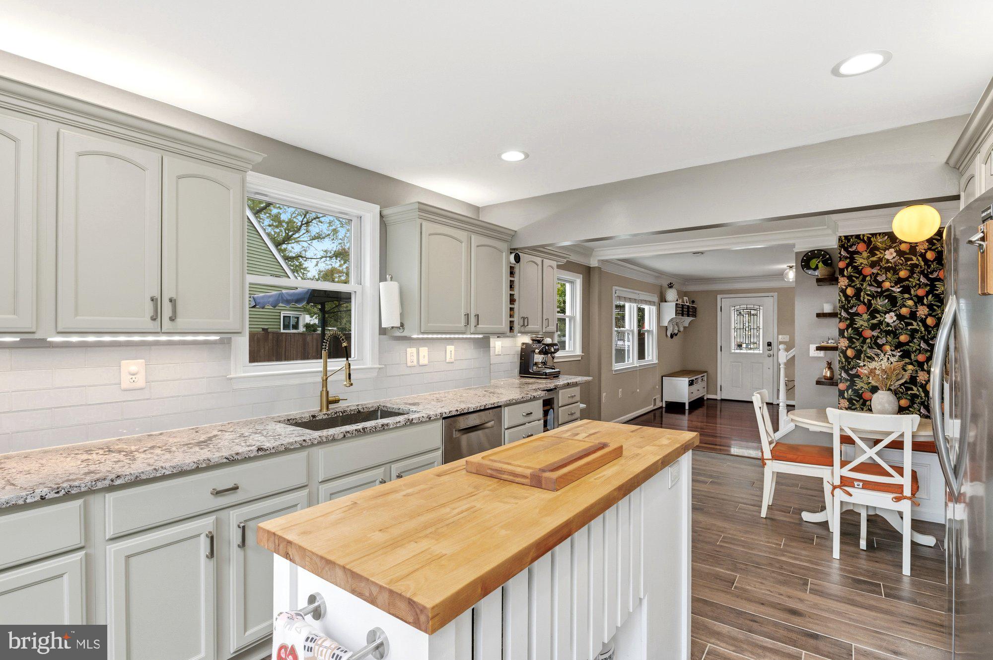 6809 Duke Drive Alexandria, VA 22307 - Photo 12 of 30 a kitchen with stainless steel appliances granite countertop a sink and cabinets