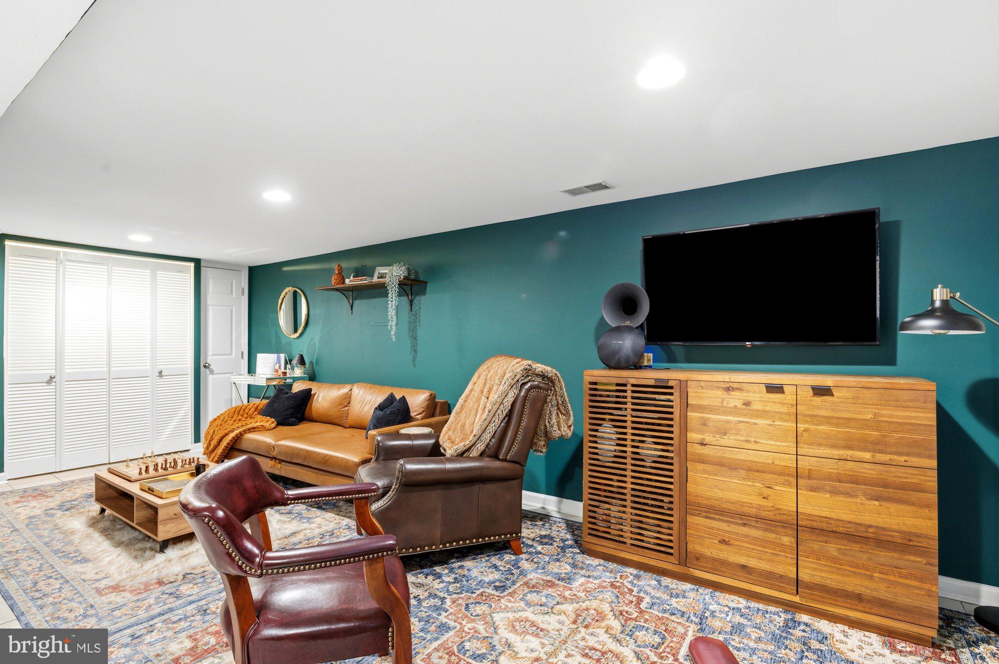 6809 Duke Drive Alexandria, VA 22307 - Photo 24 of 30 a living room with furniture and a flat screen tv