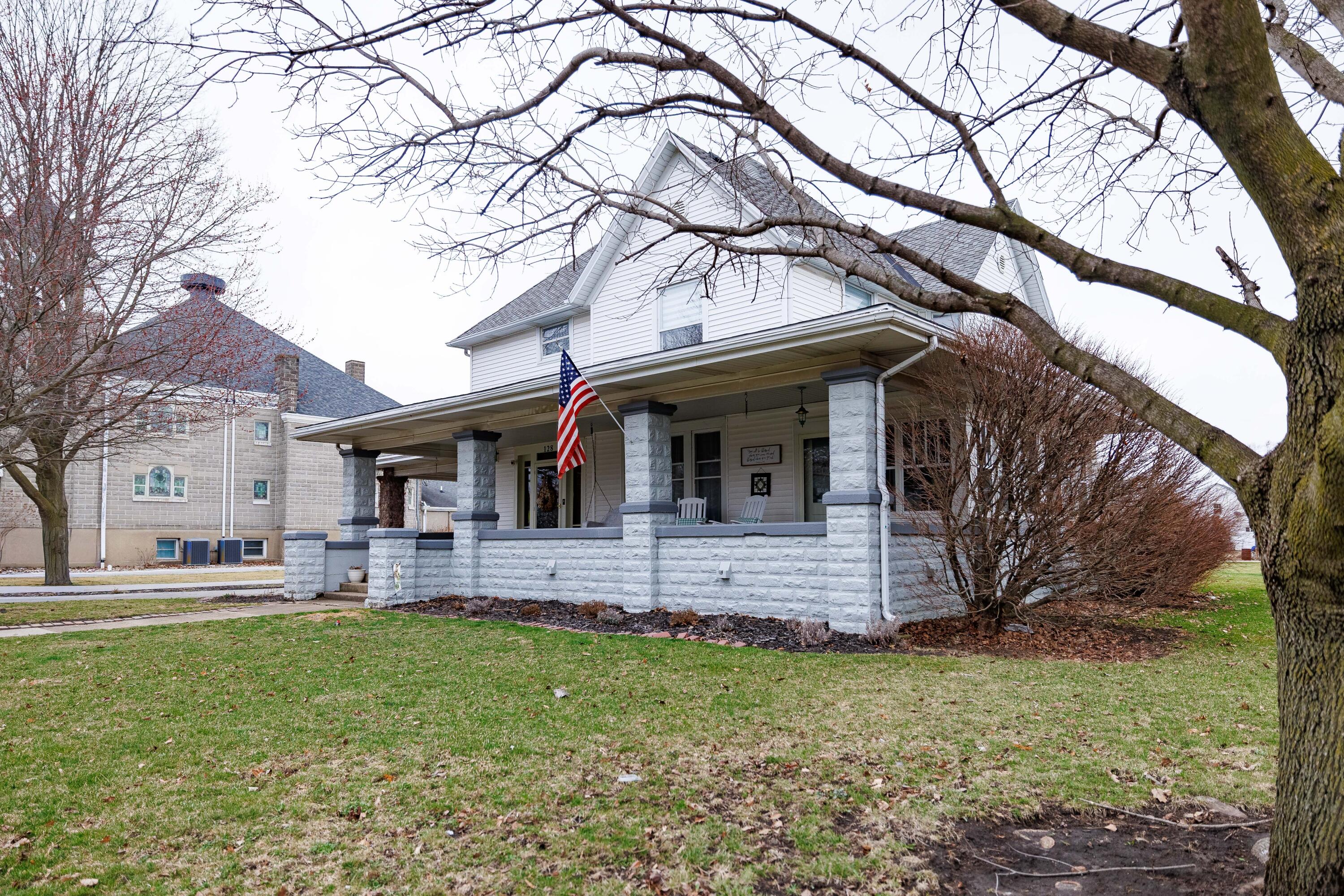 128 East Main Street Brook, IN 47922 - Photo 11 of 68 a front view of house with yard and seating