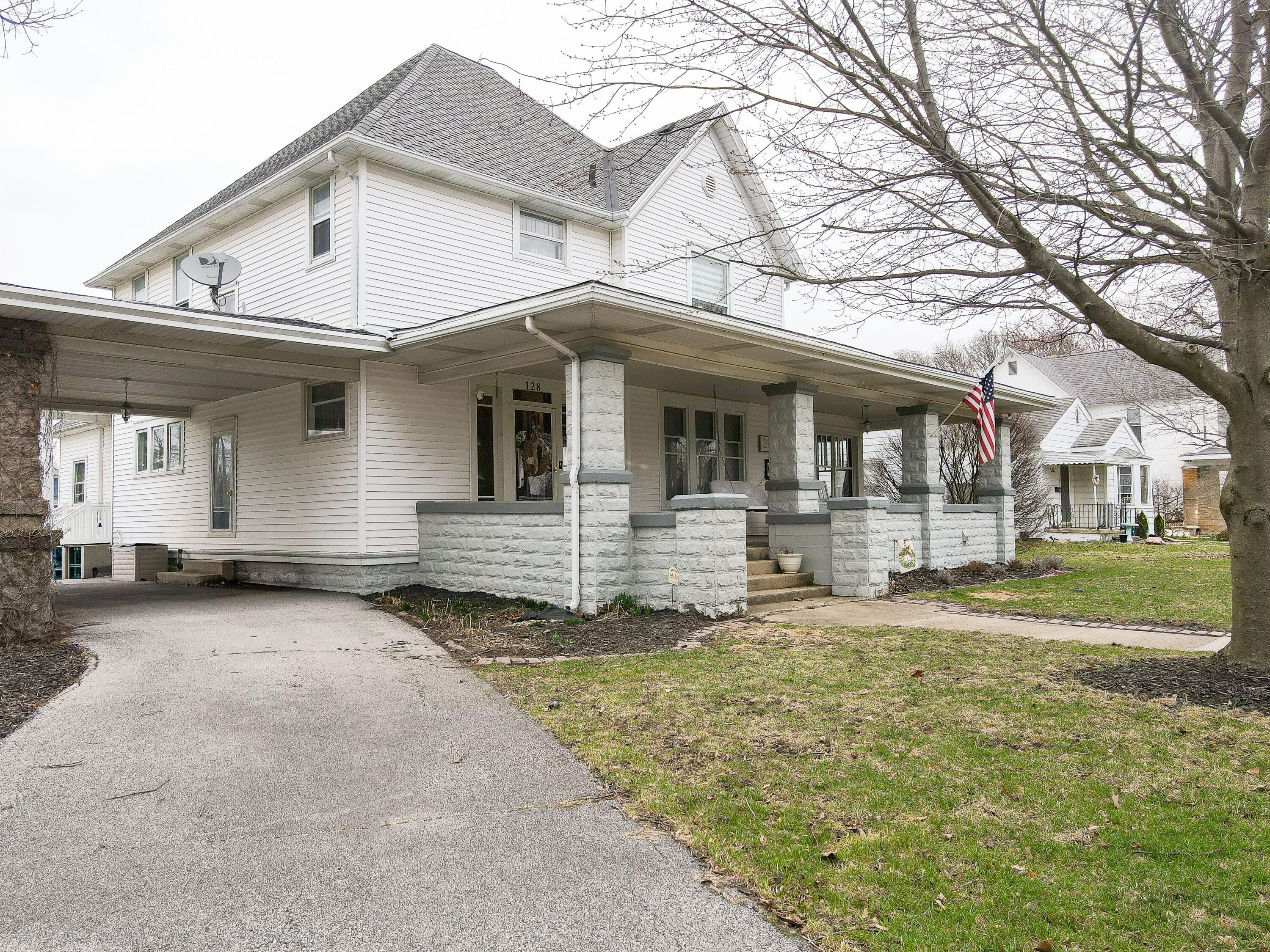128 East Main Street Brook, IN 47922 - Photo 2 of 68 a front view of a house with a yard
