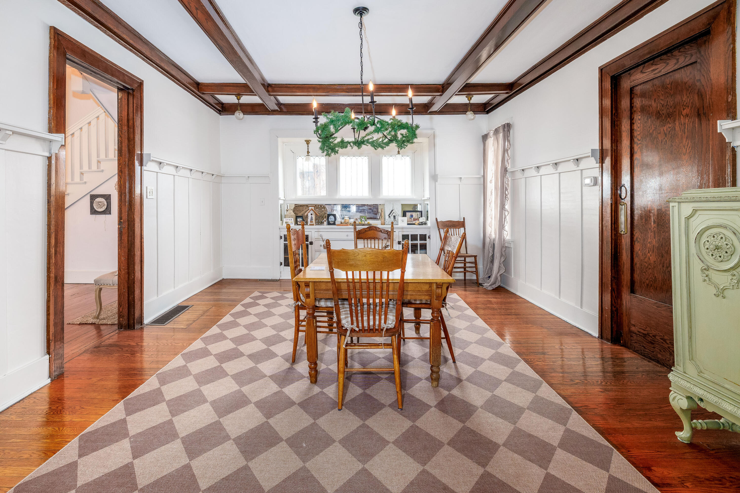 128 East Main Street Brook, IN 47922 - Photo 35 of 68 a dining room with wooden floor a chandelier a wooden table and chairs