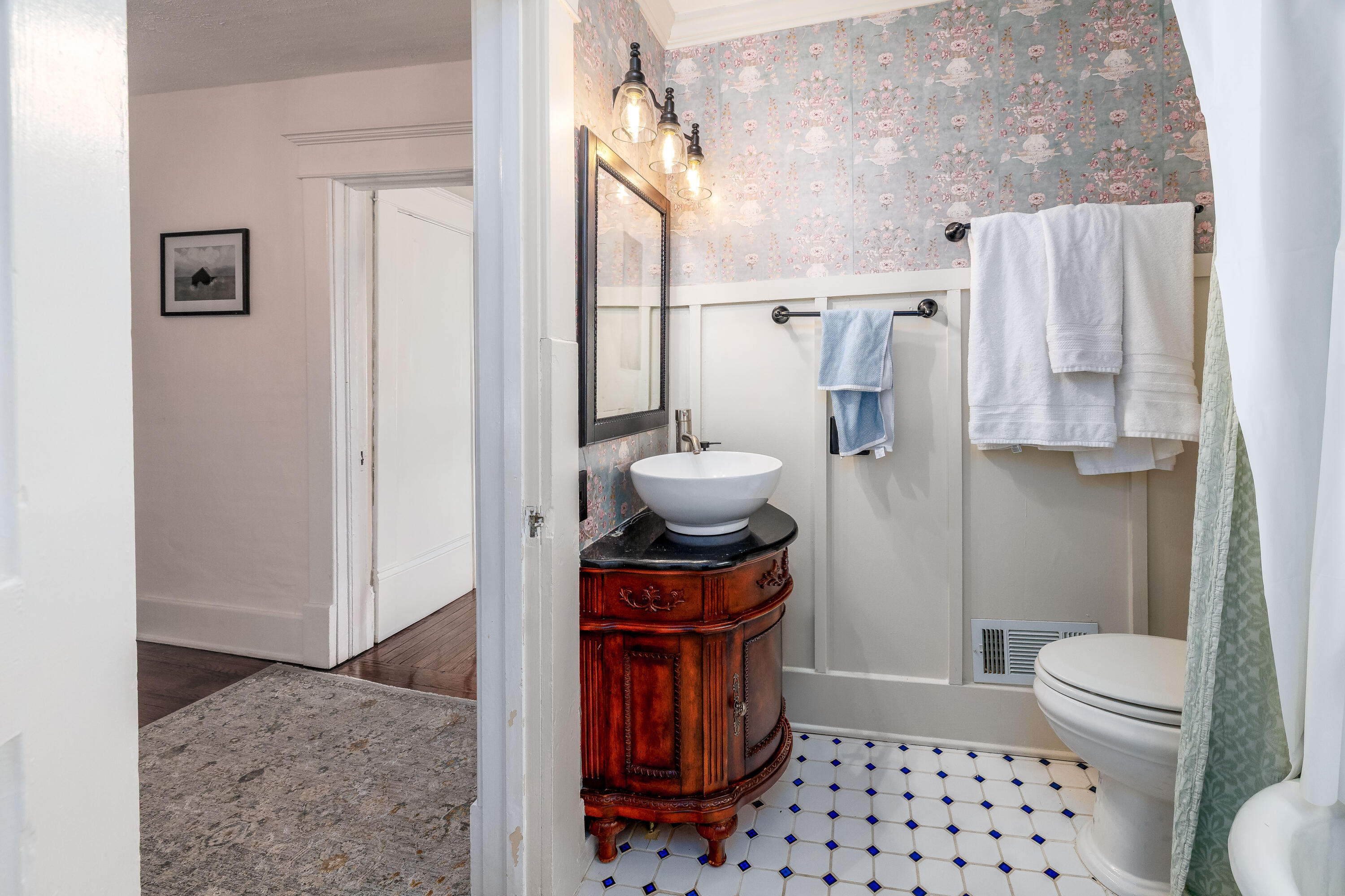 128 East Main Street Brook, IN 47922 - Photo 56 of 68 a bathroom with a granite countertop toilet a sink and a mirror