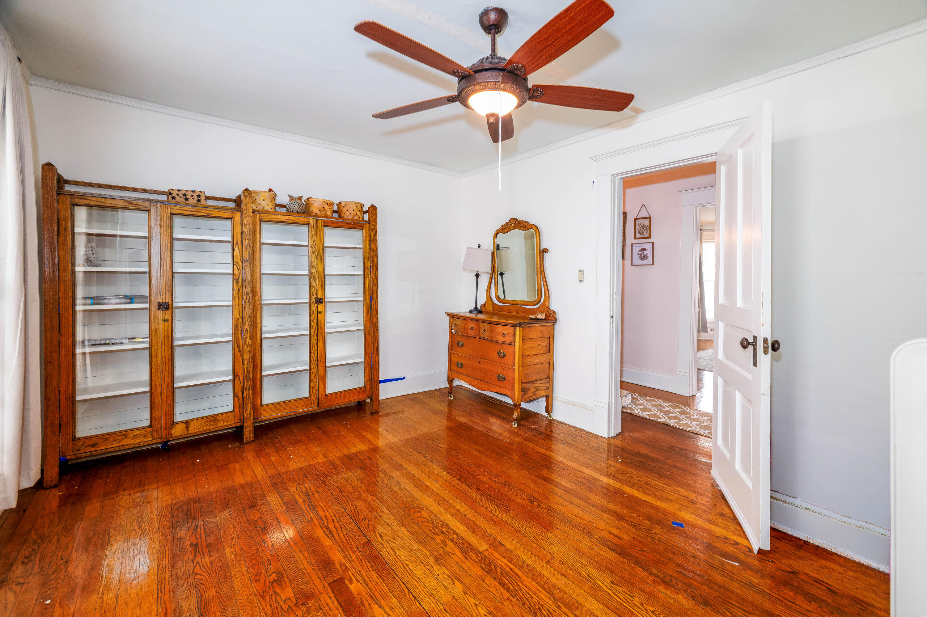 128 East Main Street Brook, IN 47922 - Photo 60 of 68 an empty room with wooden floor closet chandelier fan and windows