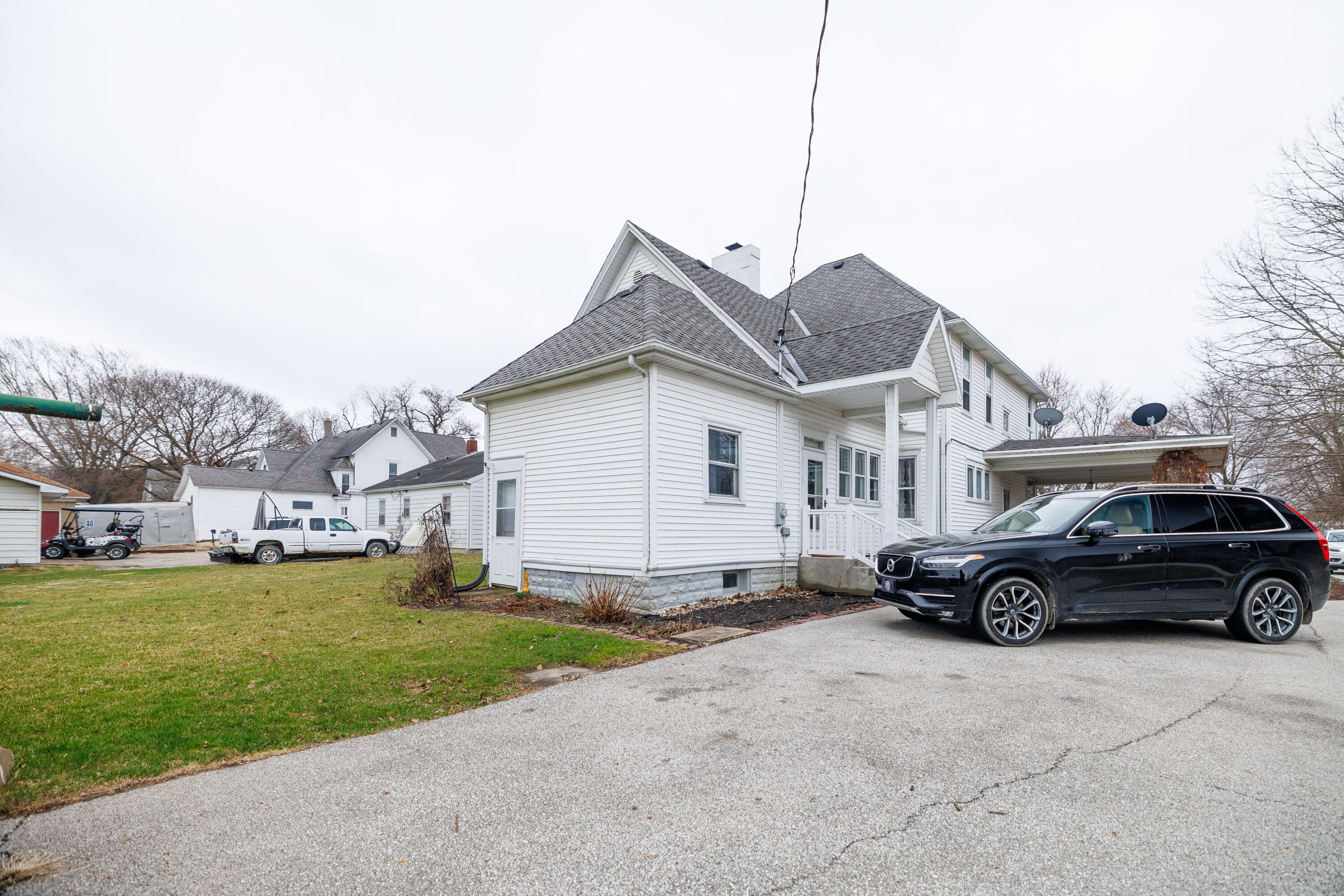128 East Main Street Brook, IN 47922 - Photo 7 of 68 a car parked in front of a house