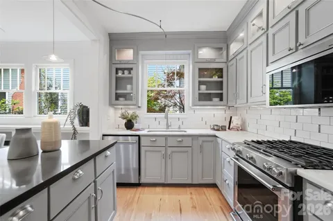 a kitchen with cabinets stainless steel appliances and a sink