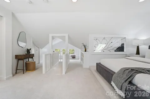 a spacious bedroom with a bed and a large window