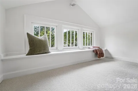a living room with a table and chairs