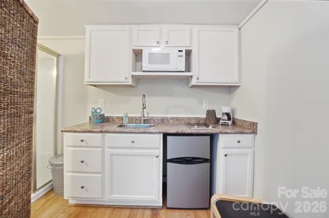 a bathroom with a granite countertop toilet a sink and a mirror