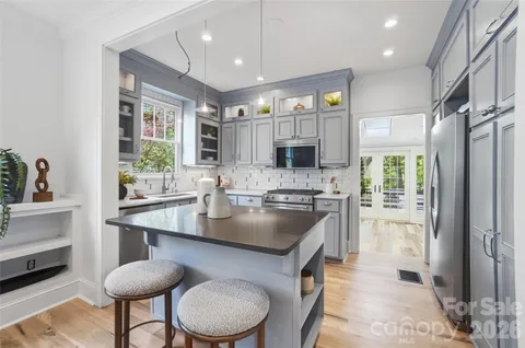 a kitchen with a sink stove and cabinets
