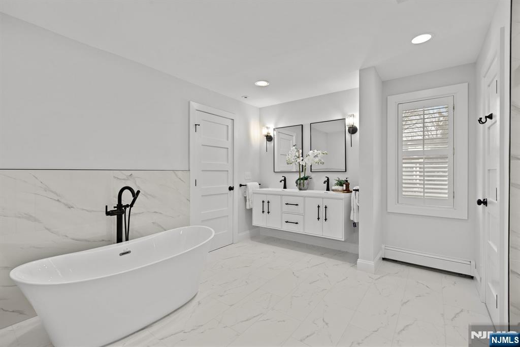 12 Midwood Road Glen Rock, NJ 07452 - Photo 13 of 30 a bathroom with a double vanity sink mirror and bathtub