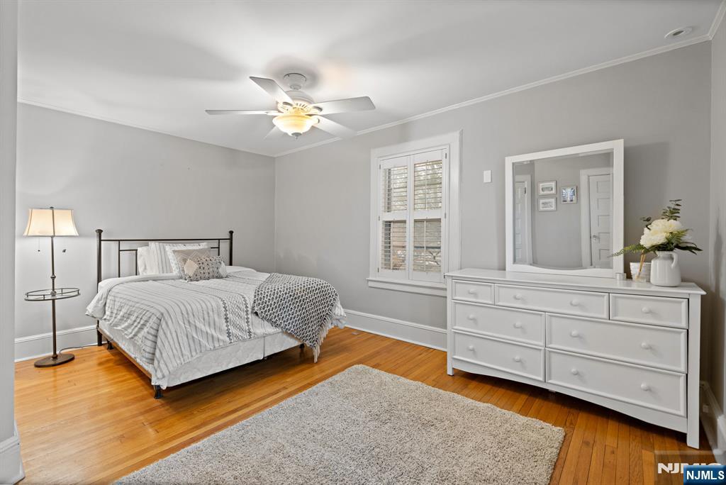 12 Midwood Road Glen Rock, NJ 07452 - Photo 15 of 30 a bedroom with a large bed and a chandelier
