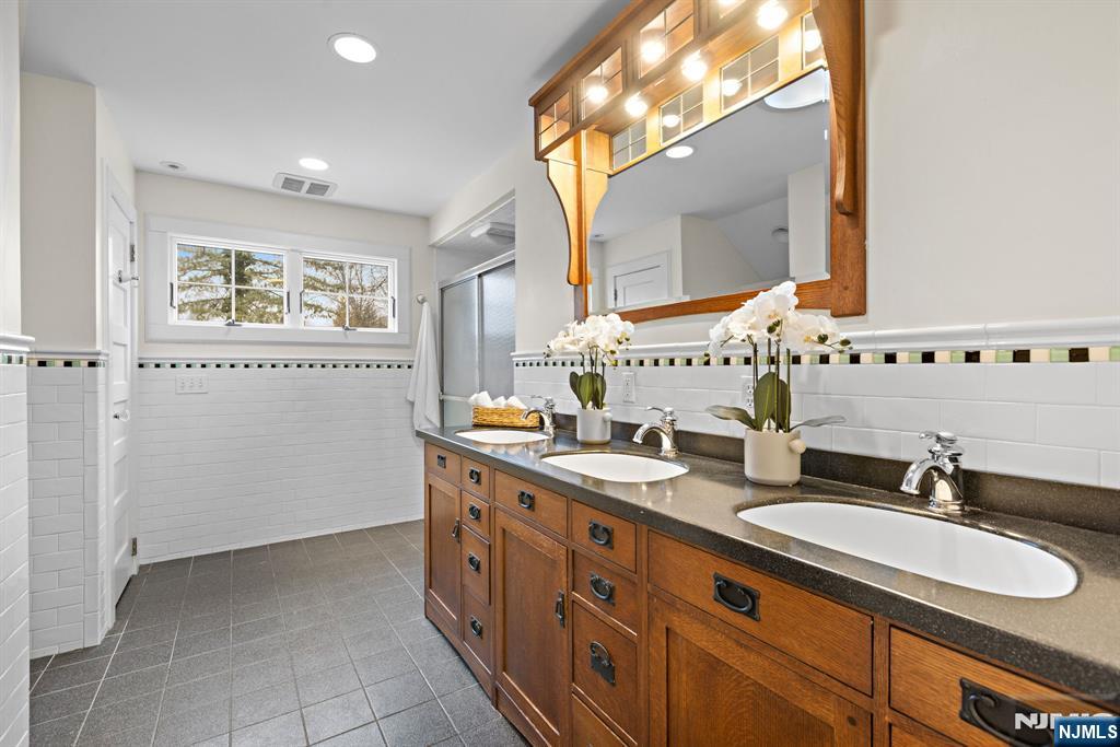 12 Midwood Road Glen Rock, NJ 07452 - Photo 19 of 30 a bathroom with a double vanity sink mirror and double