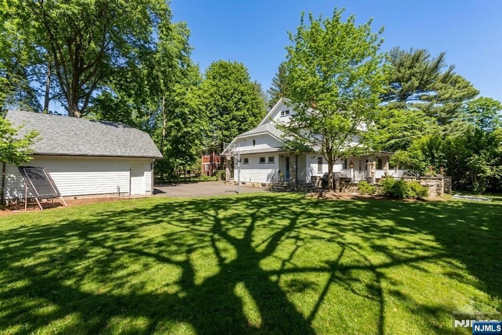 12 Midwood Road Glen Rock, NJ 07452 - Photo 27 of 30 a yellow house with trees in front of it