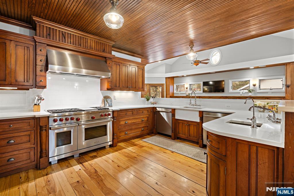 12 Midwood Road Glen Rock, NJ 07452 - Photo 5 of 30 a large kitchen with stainless steel appliances granite countertop a stove and a sink
