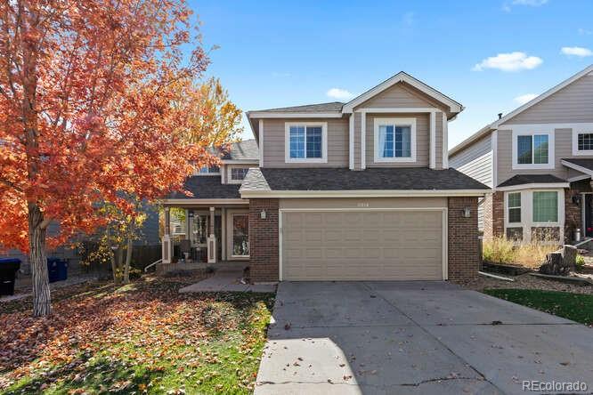 8354 Dove Ridge Way Parker, CO 80134 - Photo 1 of 38 a front view of a house with a yard and garage