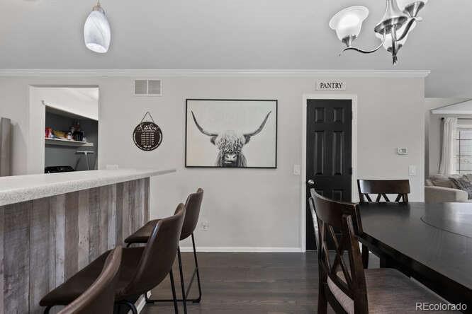 8354 Dove Ridge Way Parker, CO 80134 - Photo 12 of 38 a view of a dining room with furniture and wooden floor