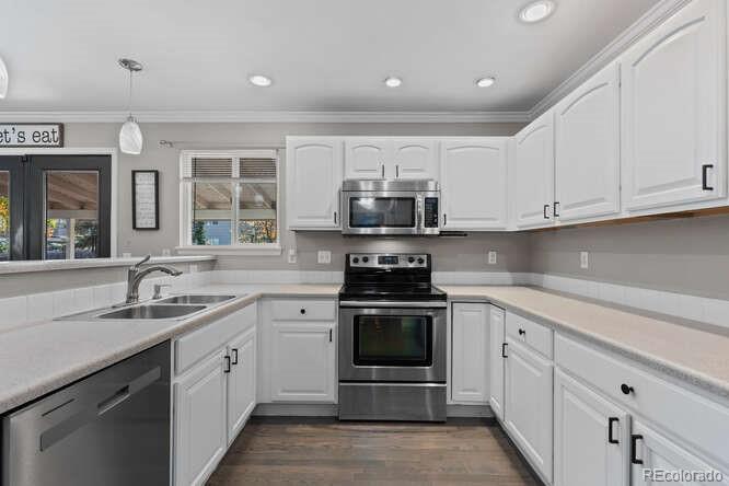 8354 Dove Ridge Way Parker, CO 80134 - Photo 14 of 38 a kitchen with stainless steel appliances granite countertop a sink dishwasher stove and oven