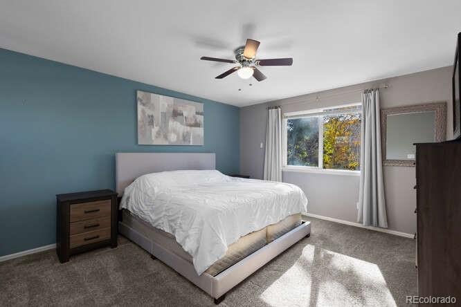 8354 Dove Ridge Way Parker, CO 80134 - Photo 18 of 38 a bedroom with a bed and a window