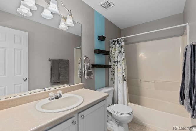 8354 Dove Ridge Way Parker, CO 80134 - Photo 21 of 38 a bathroom with a sink a toilet and shower