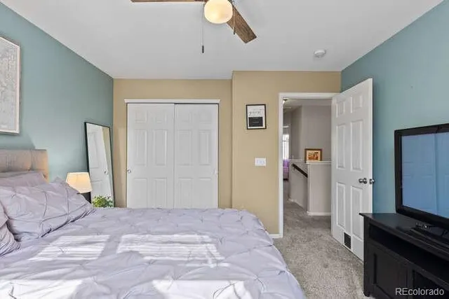 a bedroom with a bed and a television