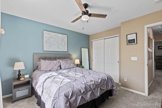 8354 Dove Ridge Way Parker, CO 80134 - Photo 23 of 38 a bedroom with a bed and a painting on the wall