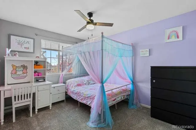 a bedroom with a bed and a baby crib