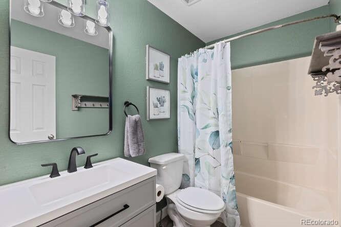 8354 Dove Ridge Way Parker, CO 80134 - Photo 28 of 38 a bathroom with a sink toilet and shower