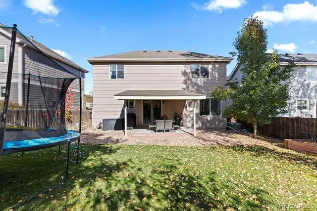a view of a house with garden and sitting area
