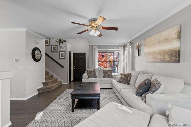 8354 Dove Ridge Way Parker, CO 80134 - Photo 6 of 38 a living room with furniture and a clock