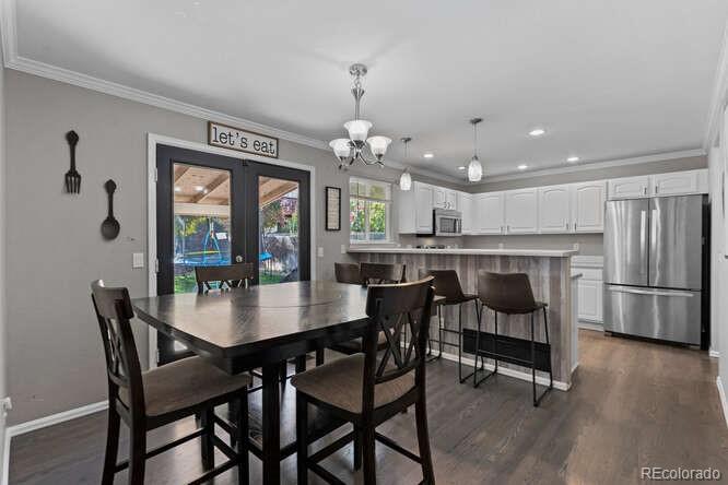 8354 Dove Ridge Way Parker, CO 80134 - Photo 9 of 38 a view of a dining room with furniture window and wooden floor