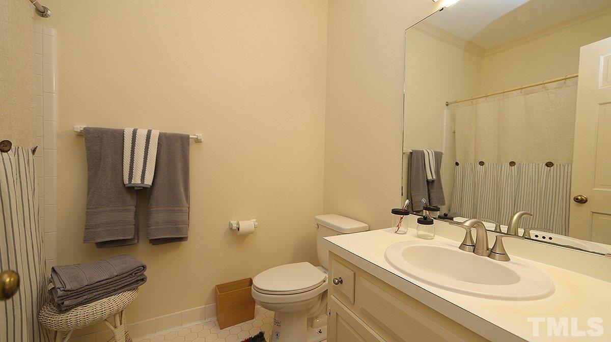 2319 Hales Road Raleigh, NC 27608 - Photo 12 of 20 a bathroom with a sink toilet and mirror