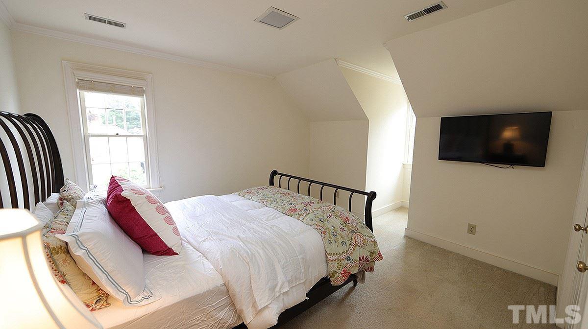 2319 Hales Road Raleigh, NC 27608 - Photo 13 of 20 a bed room with a bed tv and a window