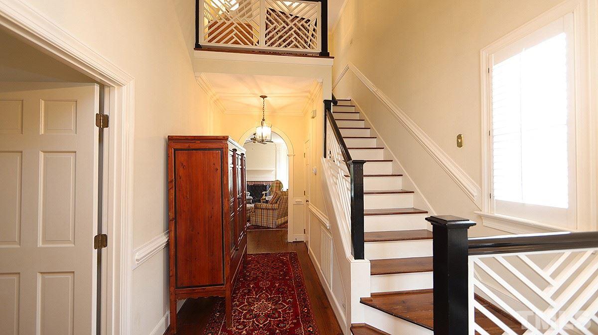 2319 Hales Road Raleigh, NC 27608 - Photo 4 of 20 a view of a hallway with wooden floor and staircase