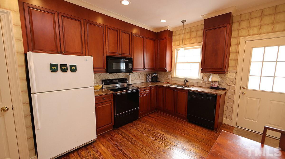2319 Hales Road Raleigh, NC 27608 - Photo 8 of 20 a kitchen with a refrigerator stove and sink