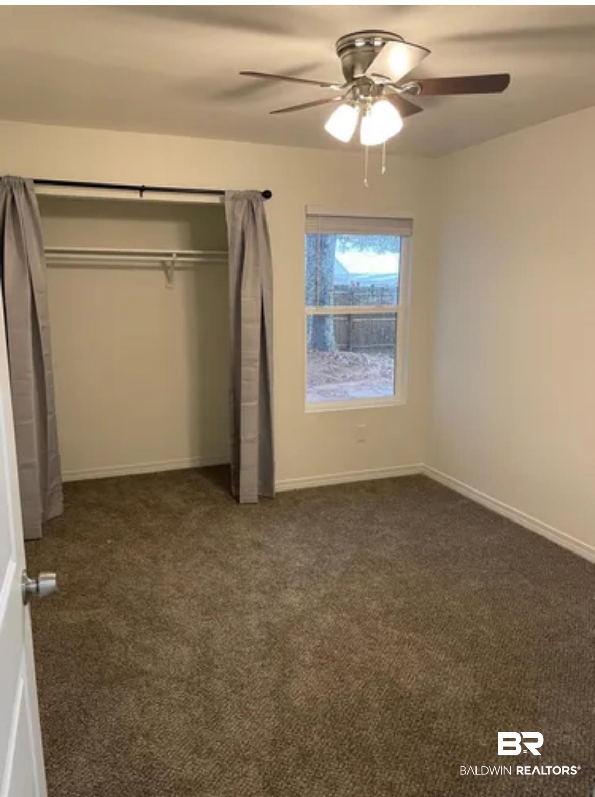 2 Canterberry Circle Foley, AL 36535 - Photo 24 of 24 Unfurnished bedroom with a closet, dark carpet, baseboards, and ceiling fan