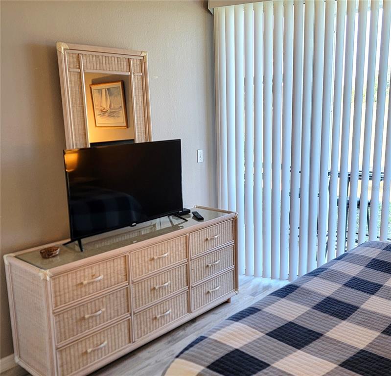 9620 Club S Circle, Unit 5105 Sarasota, FL 34238 - Photo 11 of 36 a living room with furniture and flat screen tv