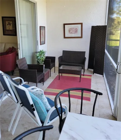 a view of a livingroom with furniture and a potted plant