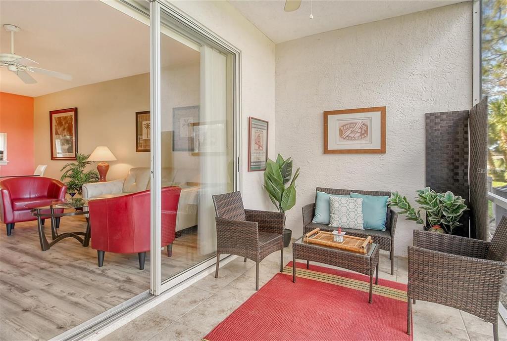 9620 Club S Circle, Unit 5105 Sarasota, FL 34238 - Photo 18 of 36 a living room with furniture and wooden floor